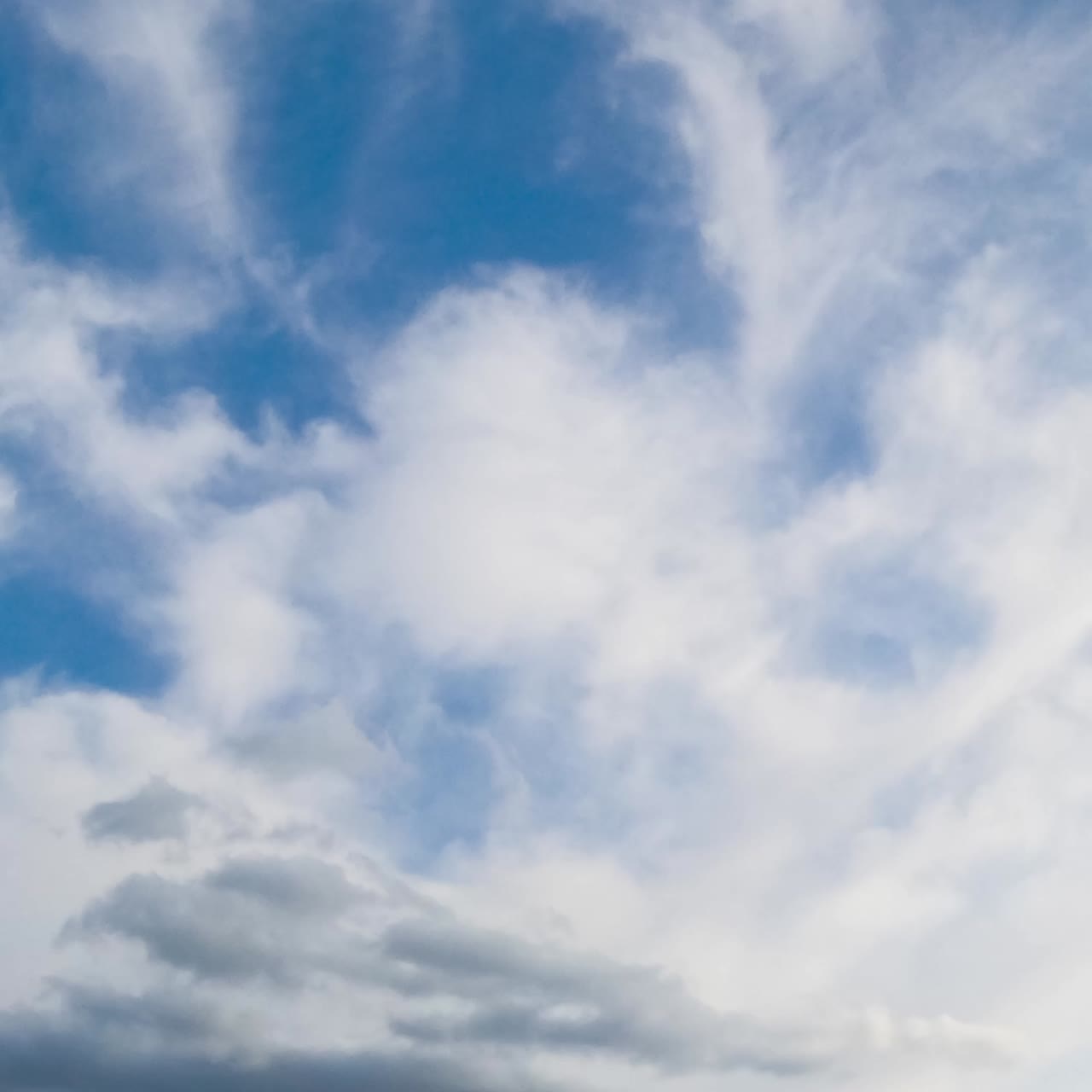 Time lapse of layer clouds on sky. Clouds flowing on blue sky