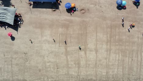 Bird's-eye-aerial-drone-shot-of-two-friends-playing-beach-soccer-with-a-field-drawn-in-the-sand-on-the-Bessa-Beach-in-the-coastal-capital-city-of-Joao-Pessoa,-Paraiba,-Brazil-on-a-sunny-summder-day