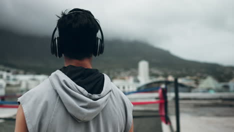 Fitness,-headphones-and-man-in-city-on-rooftop