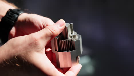 close-up of hands holding a precision metal component