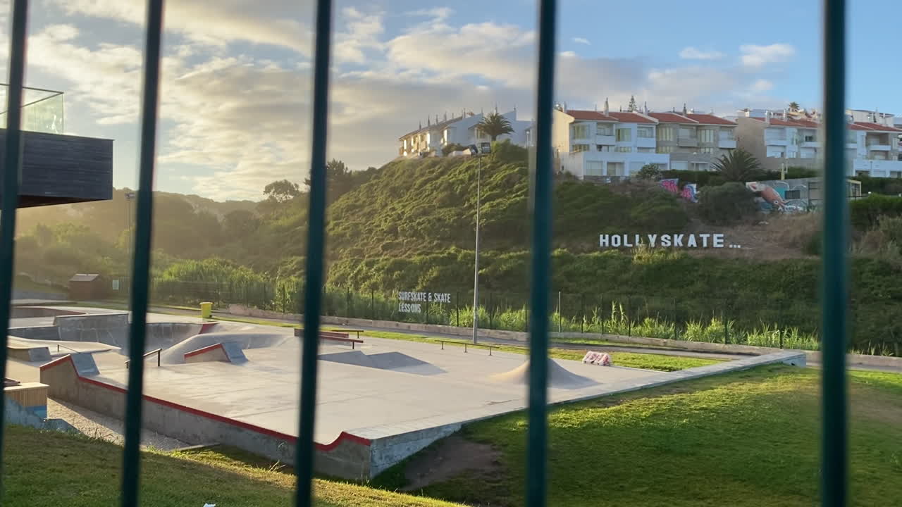 Golden evening light hits a quiet skatepark surrounded by green hills in Sanlúcar de Barrameda