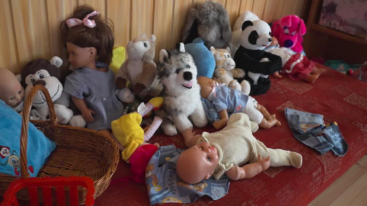 Collection of stuffed toys and dolls indoors