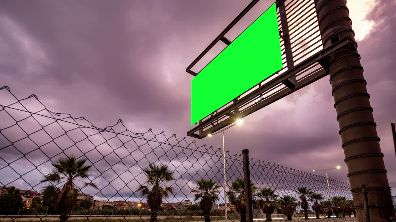 Rush of traffic on highway in city with green screen on the overhead video