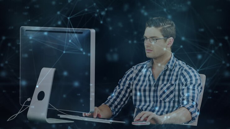Animation von Verbindungsnetzwerken über einem kaukasischen Geschäftsmann, der einen Computer benutzt