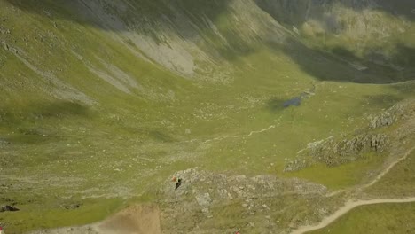 aerial drone footage of people walking across mountains in the lake district, england