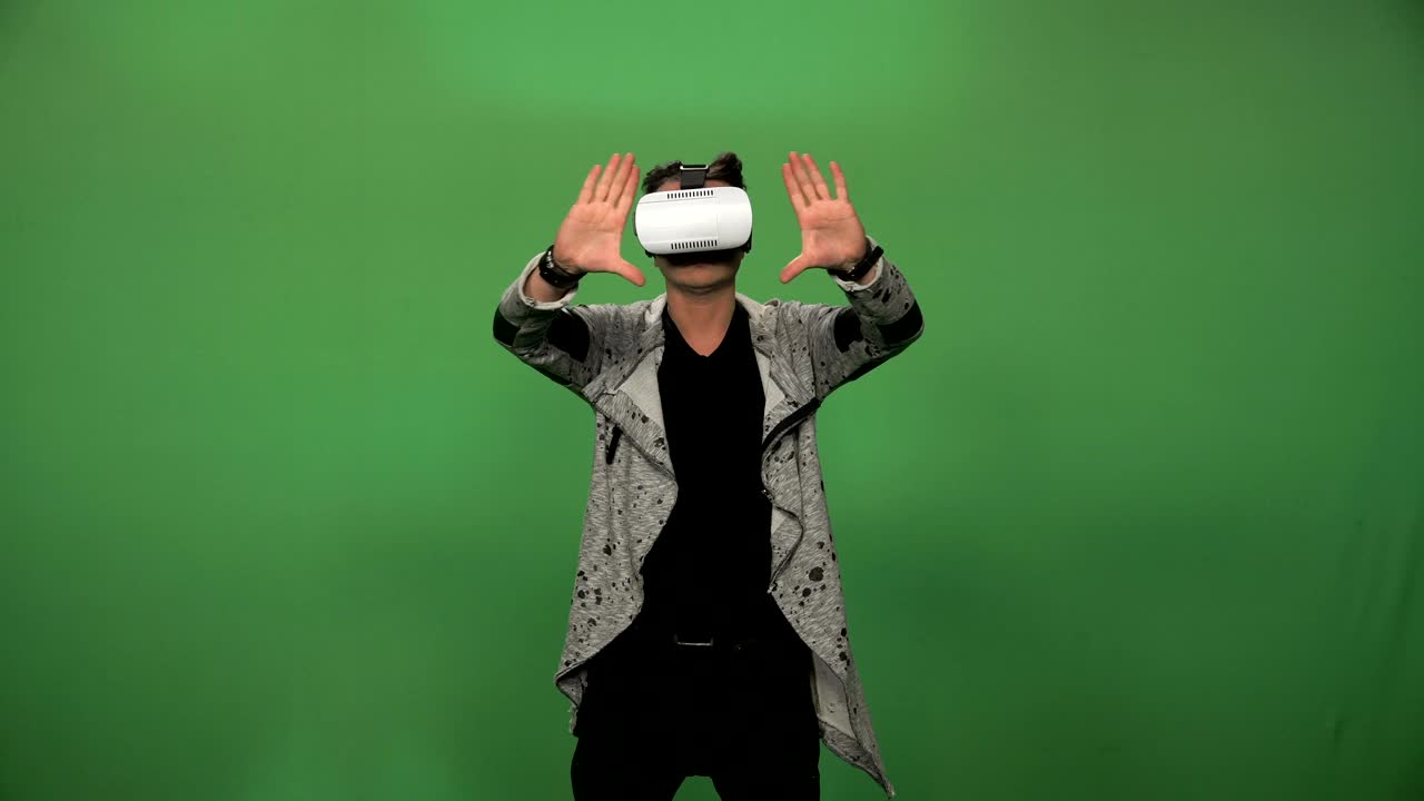Gamer using VR headset on green screen