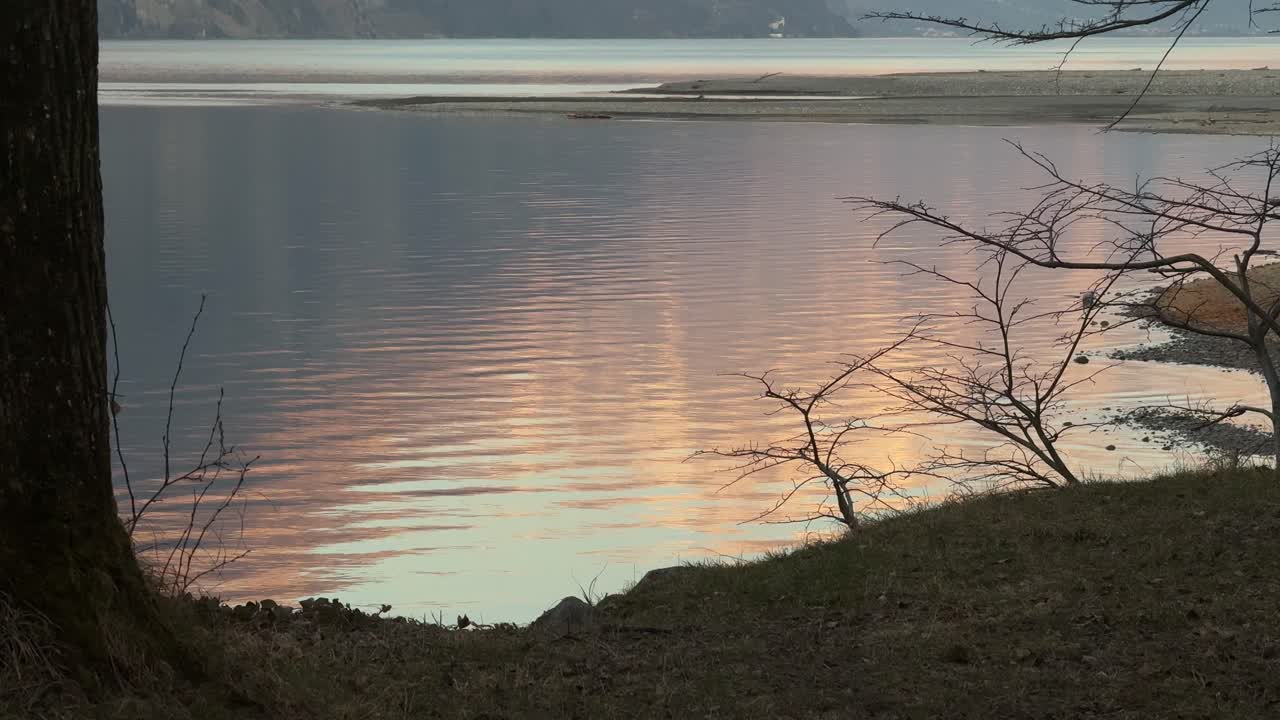 Sunset reflection water lake ripples effect waves Walensee Switzerland shore