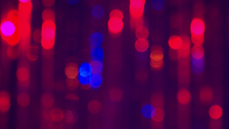 Defocused Close Up Shot Of Sparkling Tinsel Curtain In Night Club Or Disco With Flashing Strobe Lighting
