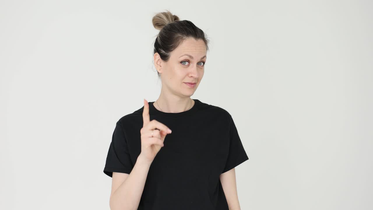 Woman in Black T-shirt Pointing Upward