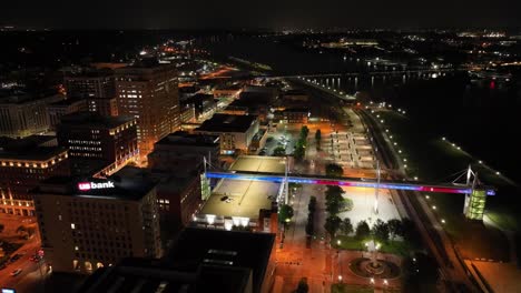 davenport, iowa pedestrian walkway lit up at night with drone video moving in