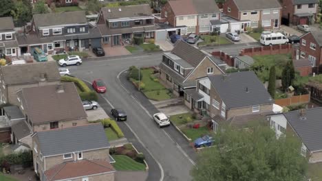 Quiet-British-homes-roads-and-gardens-residential-suburban-property-aerial-view-descending