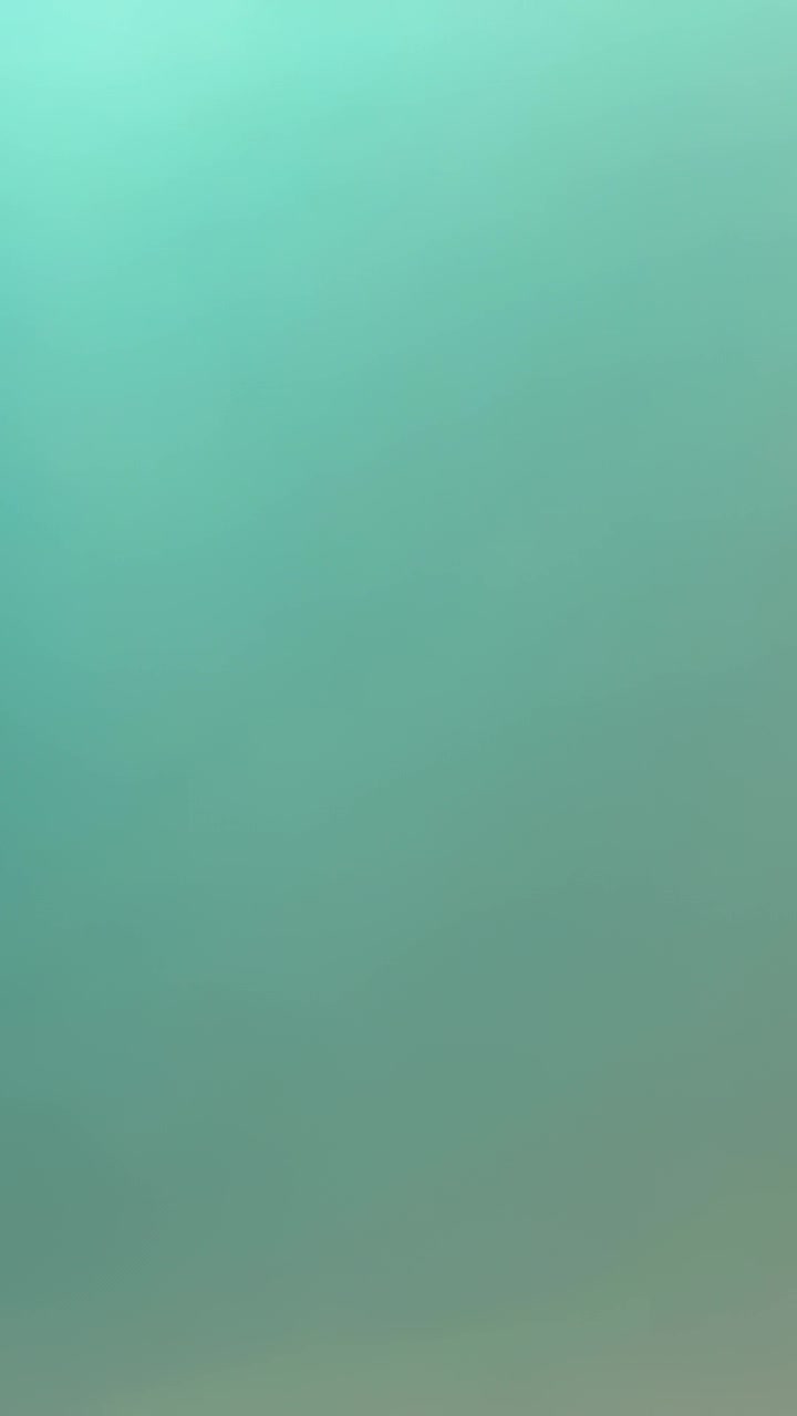 Vertical video: Pulling camera revealing wall changing from teal cyan to warm beige inside room