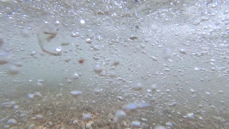 slow motion view of small waves crashing onto tanote beach on koh tao island in thailand