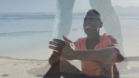 man clapping on beach, displaying animated heart icon and health data graph floating above