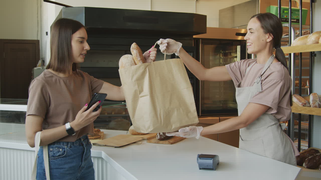 Customer purchasing bread at a bakery