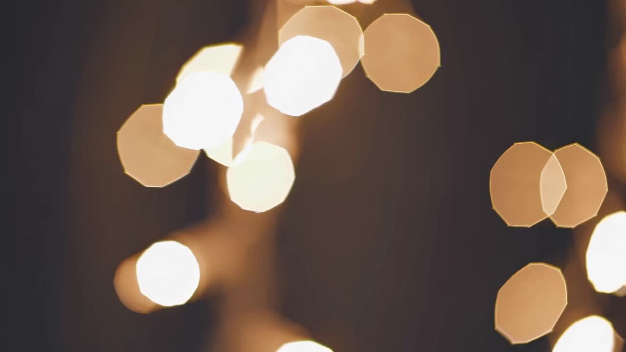 Abstract video with blurred bokeh lights in warm tones, captured from a close-up angle