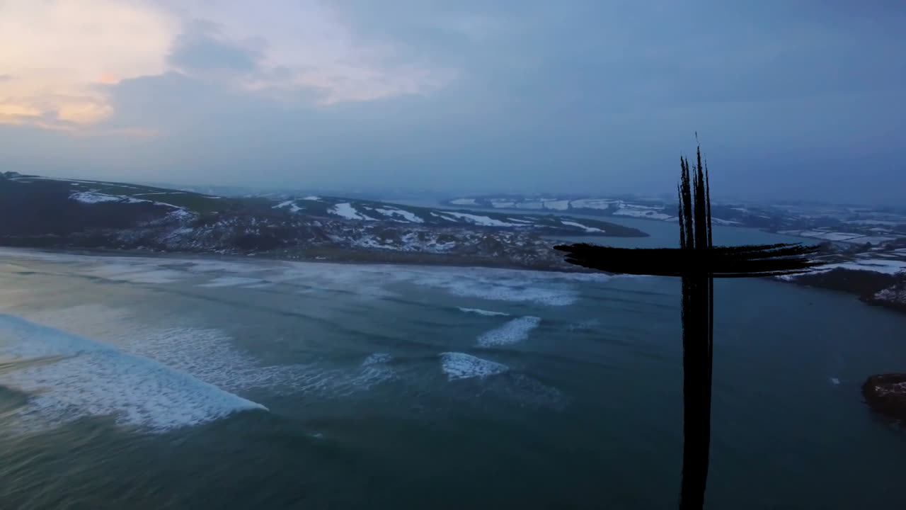 Snowy coastline with black cross symbol overlay in animation view