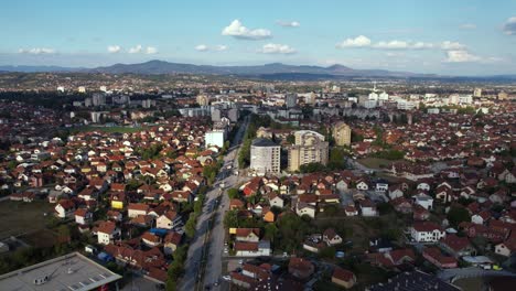 aerial view of cacak city buildings and streets on sunny summer day, serbia, drone shot