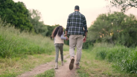 father and daughter walking in the park