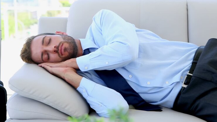 Businessman sleeping on the couch
