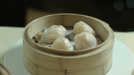 chinese dumplings served in the wooden steamers