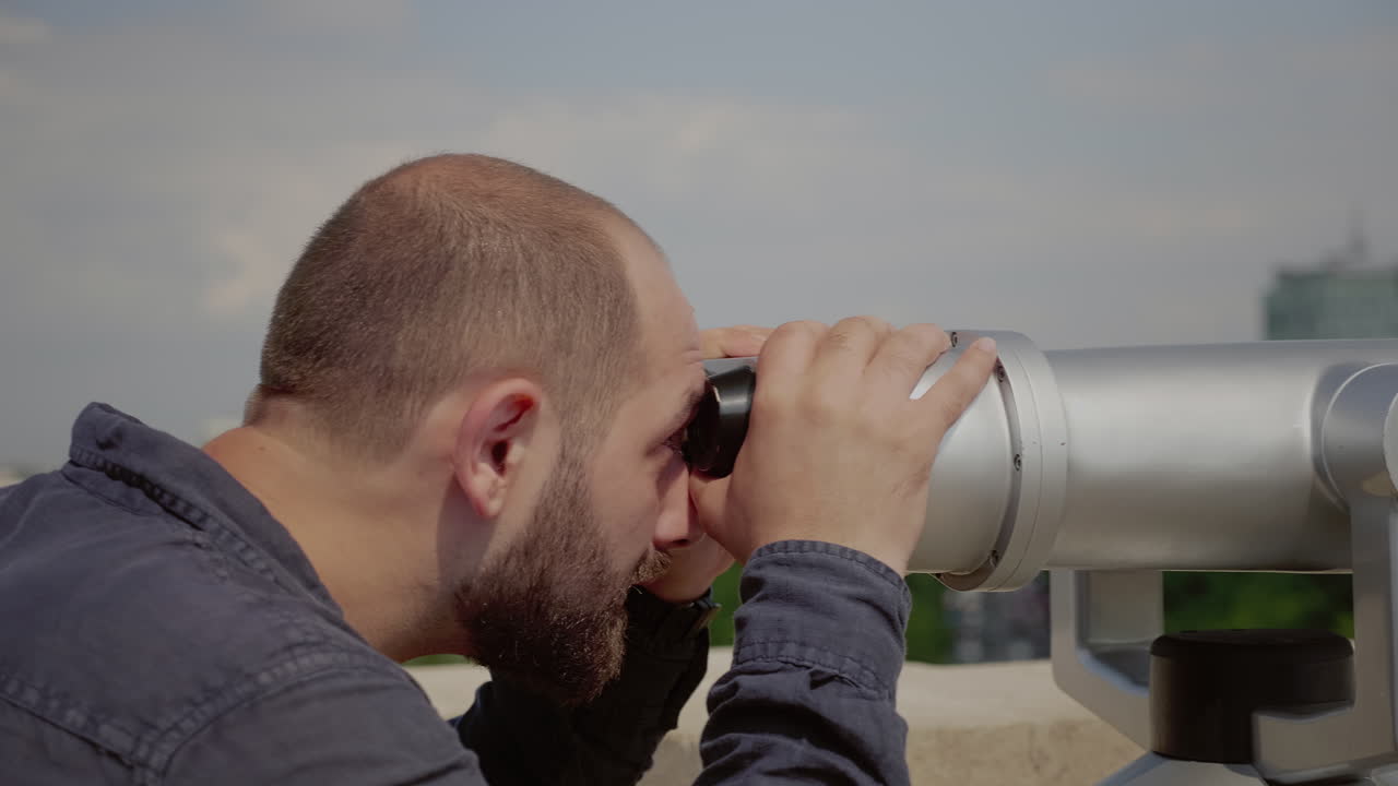 Close up of caucasian man looking through telescope lens