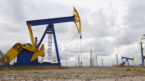 mechanical oil well pumpjacks at an oil field near ploiesti, romania