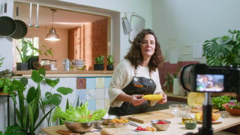 woman cooking in kitchen with camera