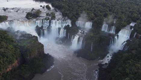 giant iguazu falls with crashing water surrounded by nature in south america