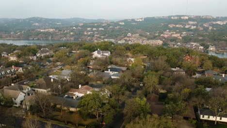 Suburban-Neighborhood-Homes-in-Tarrytown,-Austin-Texas-overlooking-Lake-Austin-Aerial-orbit-at-sunrise-in-4k