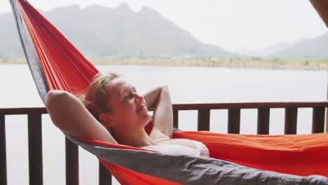 caucasian woman spending time at home, resting outside the cabin