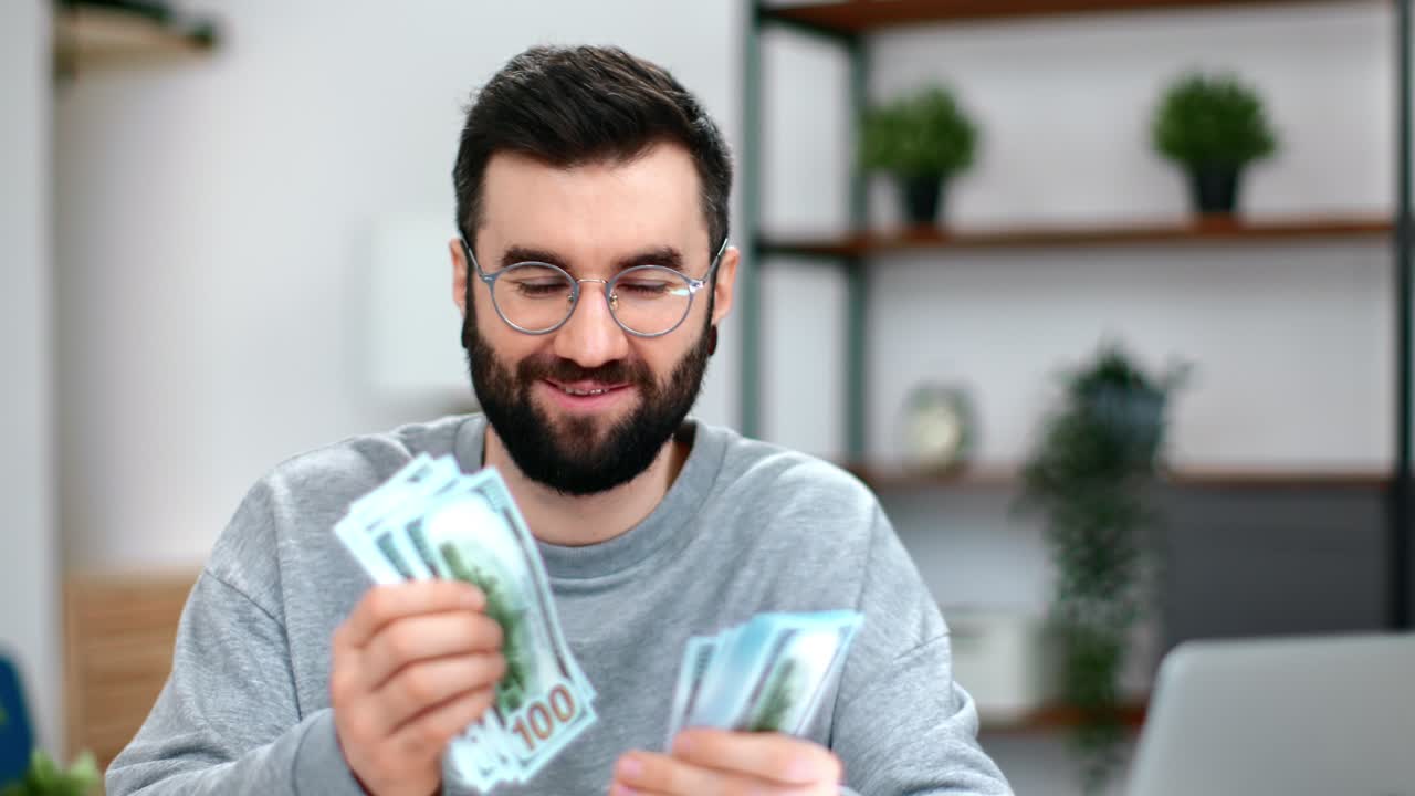 Overjoyed business man counting stack cash money dollar profit salary wage earnings office workplace