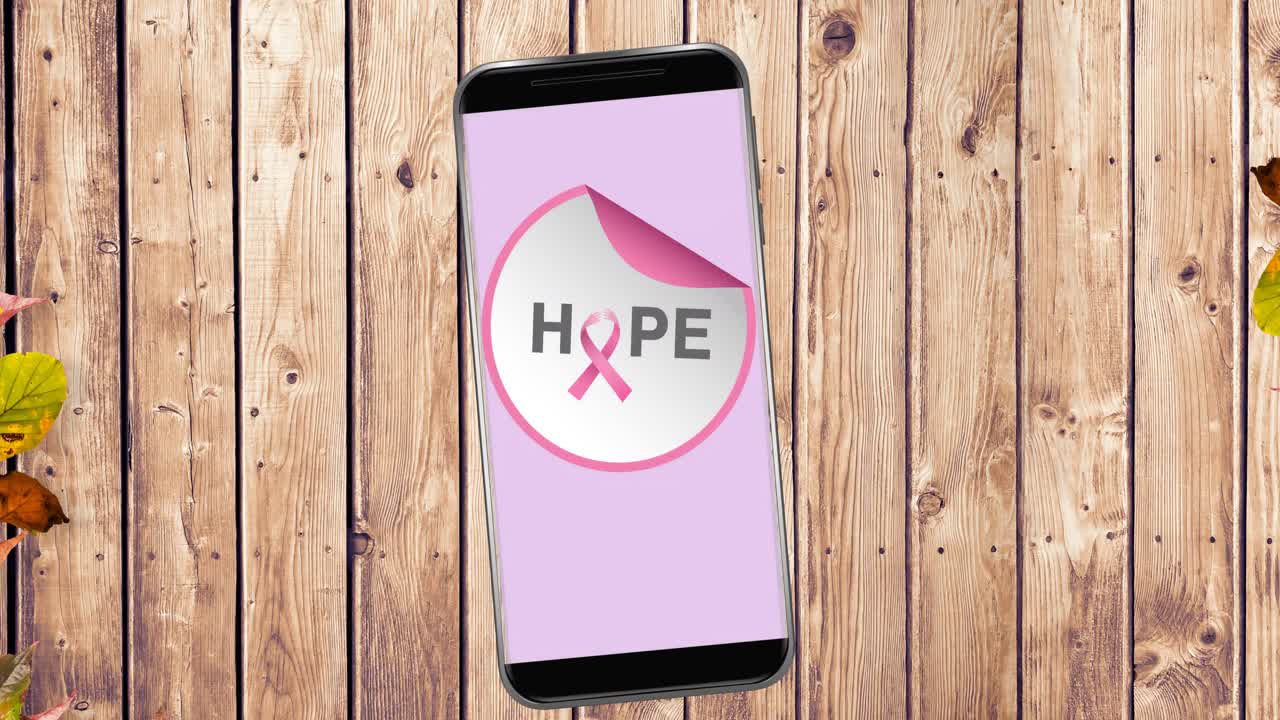 Animation of pink breast cancer ribbon logo with hope text on smartphone screen