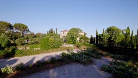 big villa being shown that is hidden behind some trees