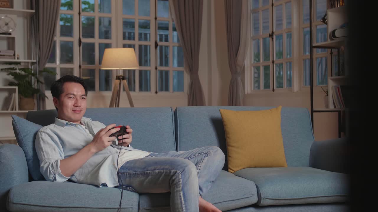 Handsome Man Gamer Siting On Sofa Playing A Game At Home, Relax Time