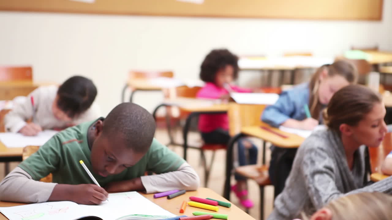 Serious pupils writing on their notebooks
