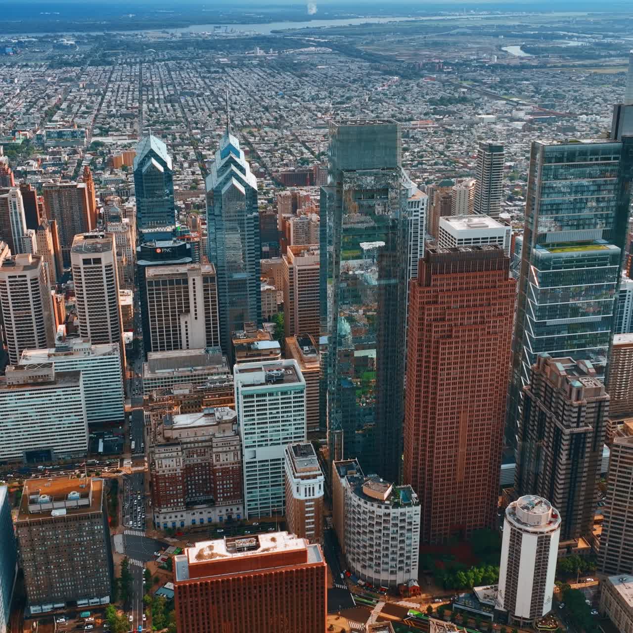 Top view on Philadelphia group of skyscrapers at daytime. Vast cityscape limited by the rivers at backdrop