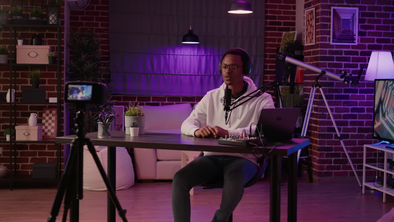 African american vlogger streaming live internet show using digital video camera for social media