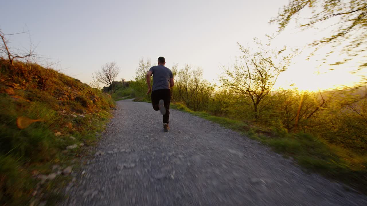 Giovane uomo che corre in una foresta al tramonto, movimento energico e suggestivo.
