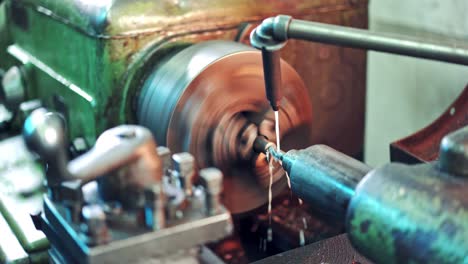 process of cutting metal in turning lathe on the industrial factory background. metalworking details and parts on lathe at industrial factory in manufacturing background