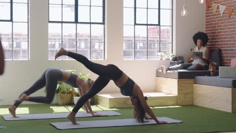 young business women practice yoga meditation together in office doing dolphin pose enjoying mindfulness exercise relaxing on lunch break