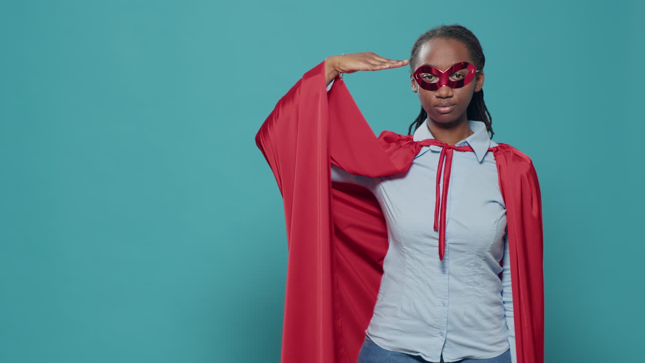 Portrait of woman superhero doing military salute