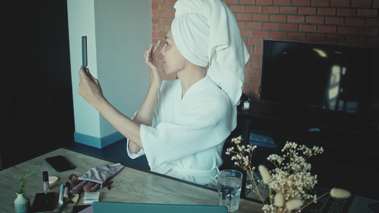 Woman Applying Eye Masks and Makeup