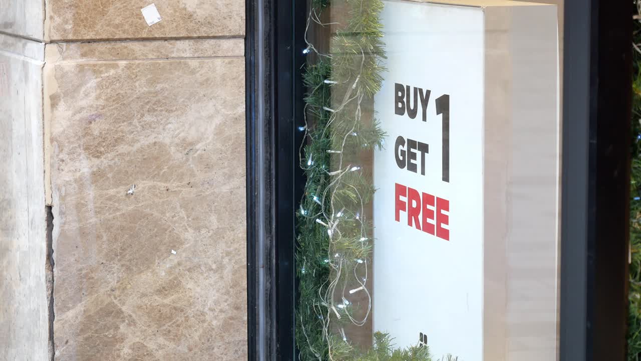 Buy One Get One Free Sign in Store Window