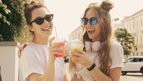 two friends enjoying drinks outside