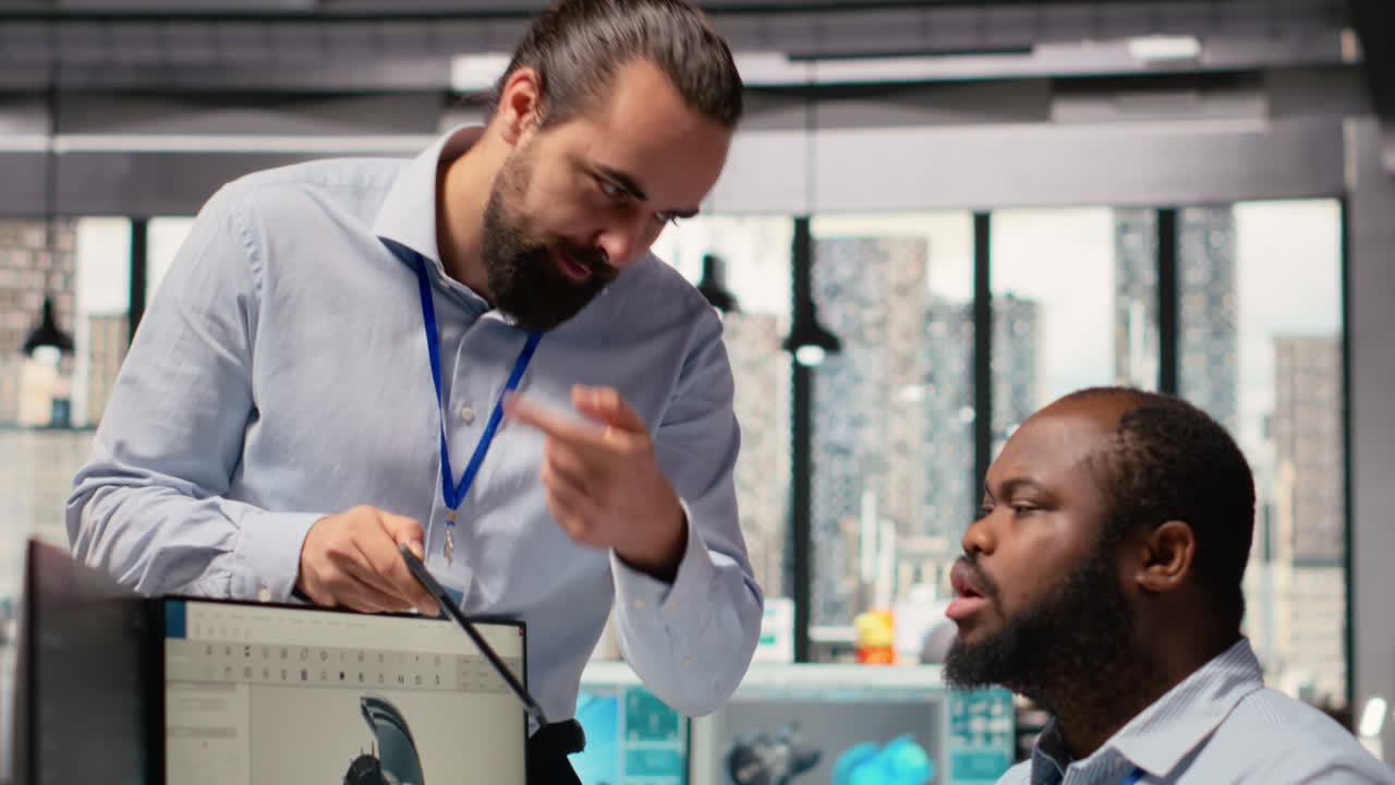 Manager Overseeing Engineer Using Cad App To Optimize Wind Turbine Design