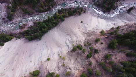 Birdseye-view-of-river-snaking-through-a-forest-in-British-Columbia,-Canda