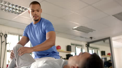 assisting patient with leg exercises, physical therapist during rehabilitation session