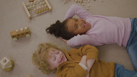 children laughing on the floor