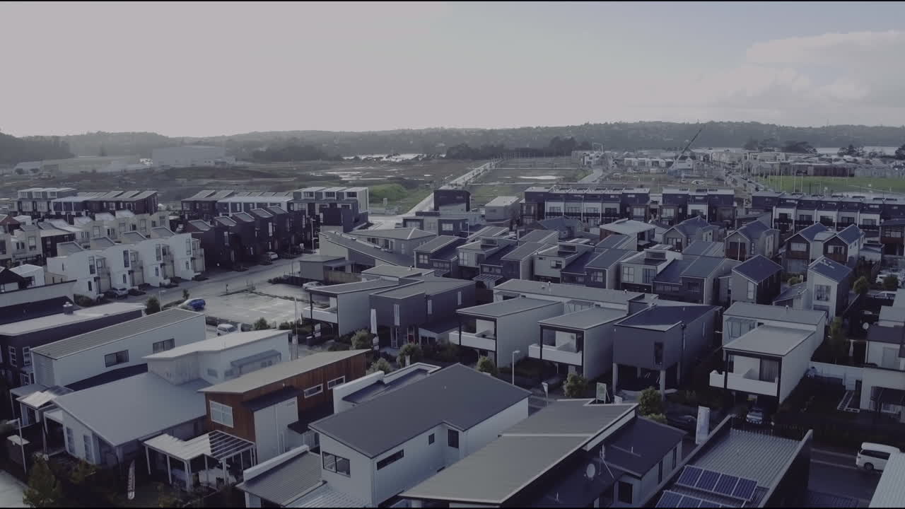 Aerial drone flying over park looking over new build housing of Hobsonville Point in Auckland, New Zealand circa